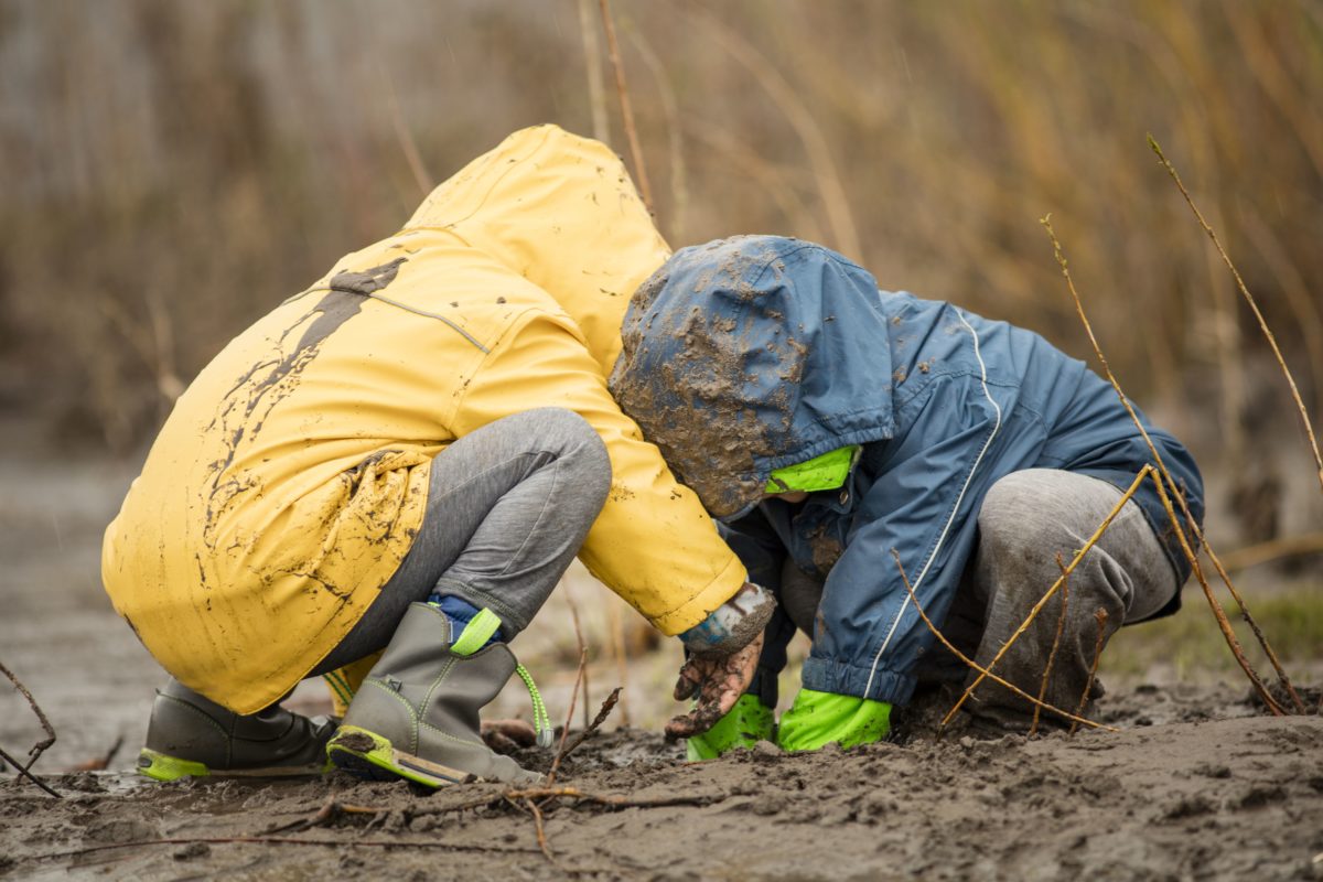 Two children are playing in nature