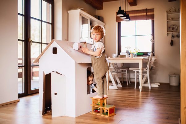 Child plays at home and learns to reuse objects to respect the environment